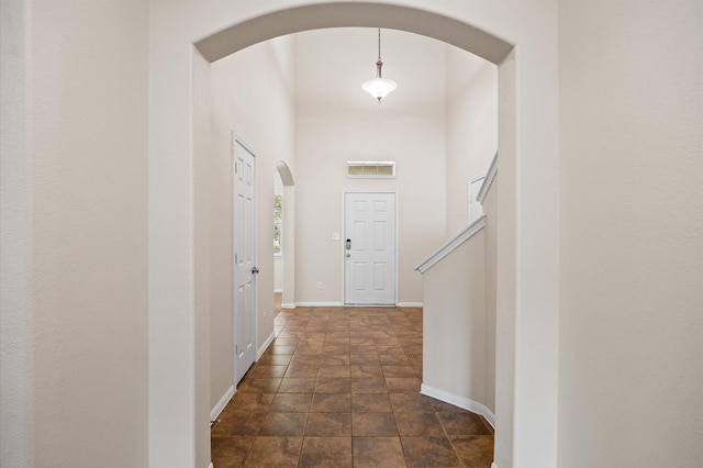16606 River Wood Ct, Crosby, TX 77532 - corridor with arched walkways and dark stone finish flooring