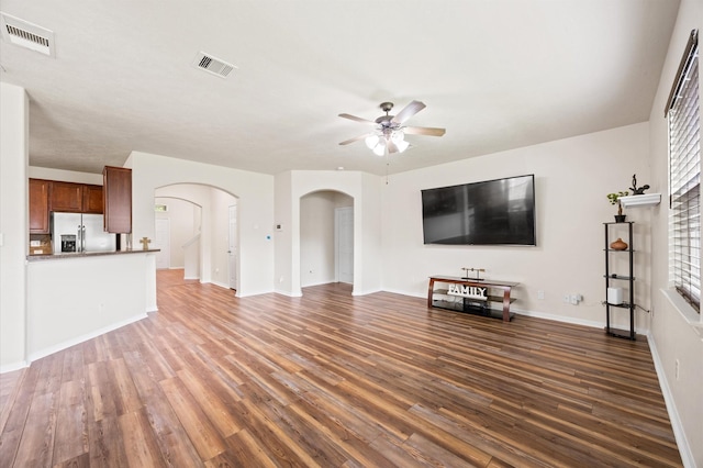 16606 River Wood Ct, Crosby, TX 77532 - unfurnished living room featuring arched walkways, ceiling fan, and wood finished floors