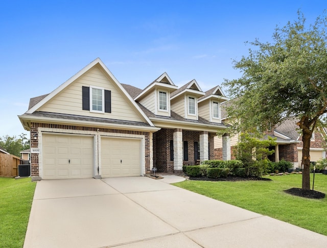16606 River Wood Ct, Crosby, TX 77532 - view of front facade with a front lawn, concrete driveway, covered porch, and brick siding