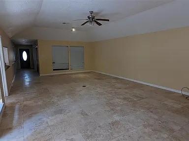 7822 Albin Ln, Houston, TX 77071 - unfurnished living room with lofted ceiling and a ceiling fan
