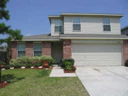 18438 Atascocita Meadow Dr, Humble, TX 77346 - traditional-style house featuring a garage, driveway, a front yard, and brick siding