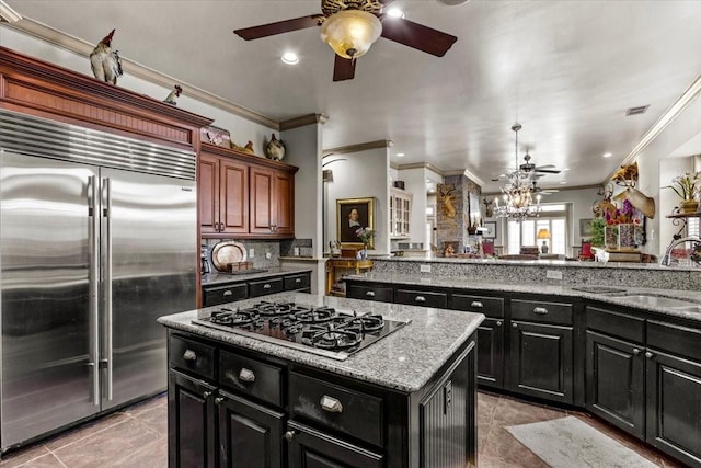 3039 Bayshore Dr, Bacliff, TX 77518 - kitchen with stainless steel built in fridge, black gas stovetop, dark cabinetry, a ceiling fan, and crown molding