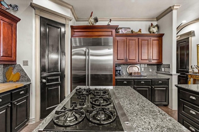 3039 Bayshore Dr, Bacliff, TX 77518 - kitchen with built in refrigerator, ornamental molding, tasteful backsplash, black gas cooktop, and light stone counters