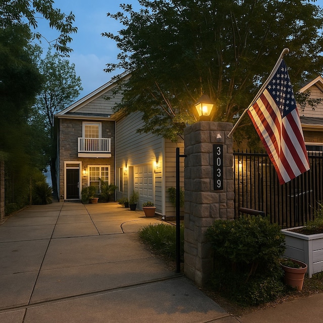 3039 Bayshore Dr, Bacliff, TX 77518 - view of front facade with a balcony, concrete driveway, and stone siding