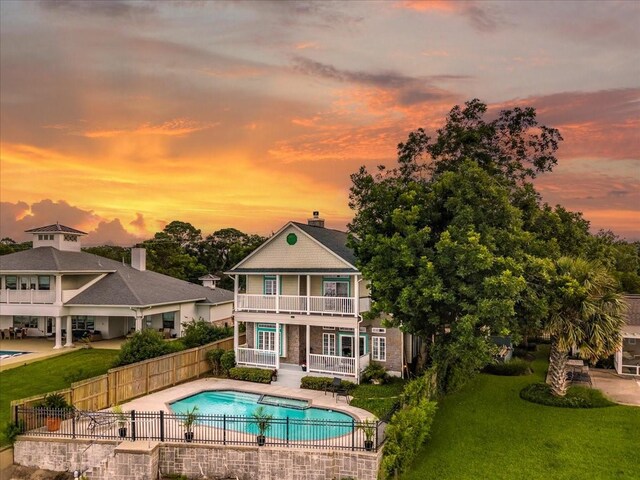 3039 Bayshore Dr, Bacliff, TX 77518 - back of house at dusk with a balcony and a patio area