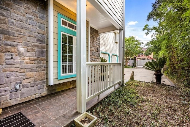 3039 Bayshore Dr, Bacliff, TX 77518 - property entrance featuring stone siding and a porch
