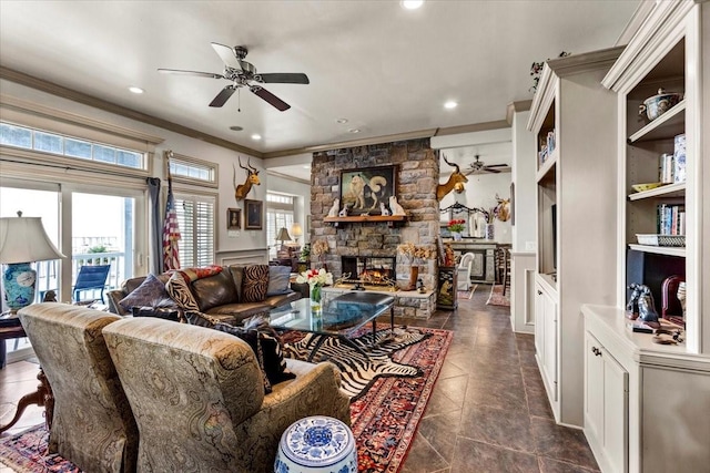 3039 Bayshore Dr, Bacliff, TX 77518 - living area with a ceiling fan, crown molding, a stone fireplace, recessed lighting, and dark tile patterned flooring