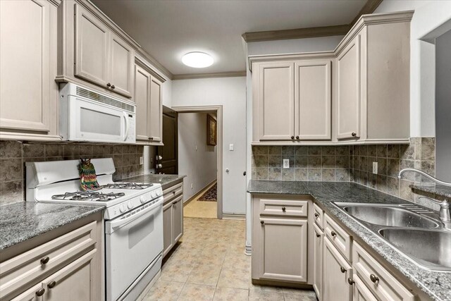 3039 Bayshore Dr, Bacliff, TX 77518 - kitchen with white appliances, crown molding, decorative backsplash, and light tile patterned floors