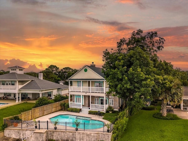 3039 Bayshore Dr, Bacliff, TX 77518 - back of house at dusk with a balcony and a patio area