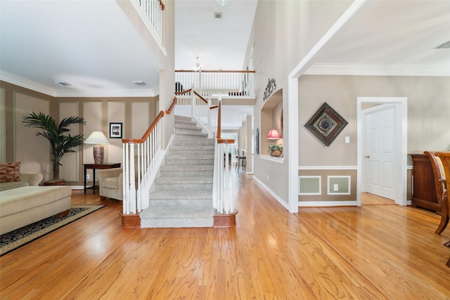 1915 Stormcroft Cir, Katy, TX 77450 - foyer with stairway, a ceiling fan, wood finished floors, crown molding, and arched walkways