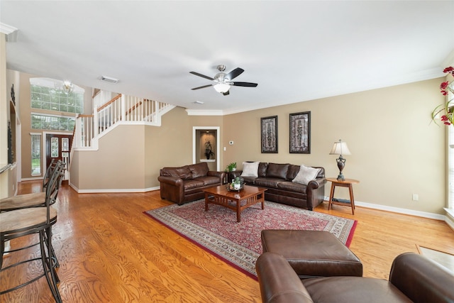 1915 Stormcroft Cir, Katy, TX 77450 - living room with wood finished floors, stairs, a ceiling fan, and ornamental molding