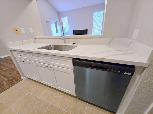 8100 Cambridge St Unit 99, Houston, TX 77054 - kitchen with dishwasher, white cabinetry, light stone counters, light tile patterned floors, and vaulted ceiling
