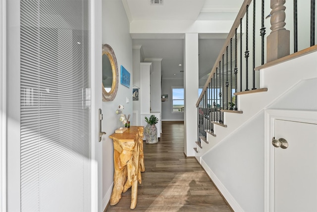 19623 Shores Dr, Galveston, TX 77554 - foyer with wood finished floors, stairs, and crown molding