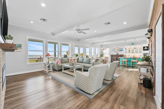 19623 Shores Dr, Galveston, TX 77554 - living area with beamed ceiling, a ceiling fan, wood finished floors, recessed lighting, and a fireplace