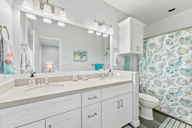 19623 Shores Dr, Galveston, TX 77554 - bathroom with double vanity, wood finished floors, and a shower with curtain