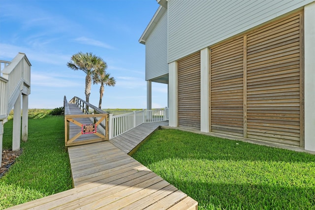 19623 Shores Dr, Galveston, TX 77554 - wooden deck featuring a lawn