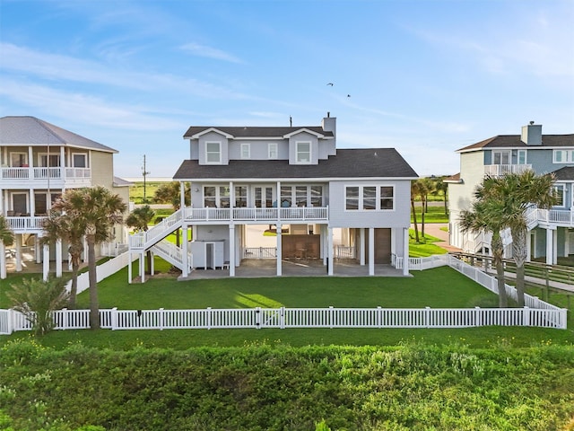 19623 Shores Dr, Galveston, TX 77554 - back of house featuring a fenced backyard, a patio, roof with shingles, and stairway