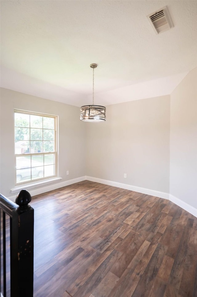 238 Almond Dr, Lake Jackson, TX 77566 - unfurnished room featuring dark wood-style floors and a chandelier