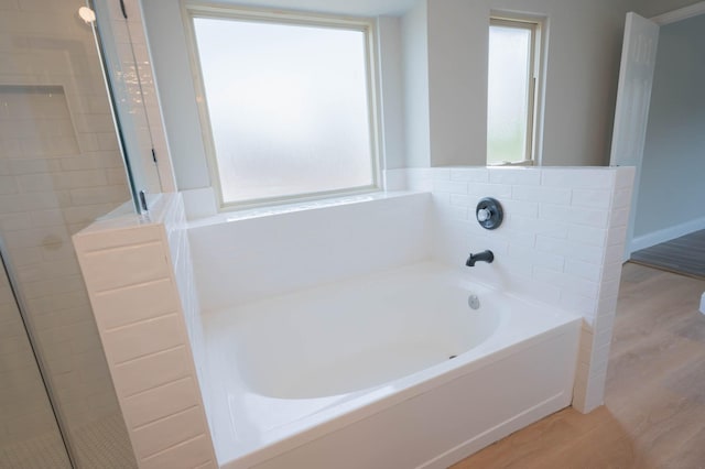 238 Almond Dr, Lake Jackson, TX 77566 - bathroom featuring wood finished floors, plenty of natural light, and a bath