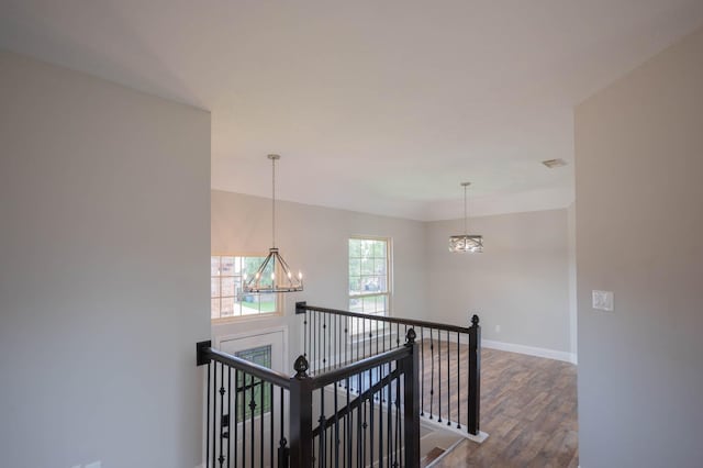 238 Almond Dr, Lake Jackson, TX 77566 - hallway with a chandelier, an upstairs landing, and dark wood-style flooring