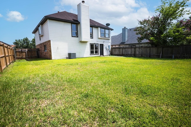 238 Almond Dr, Lake Jackson, TX 77566 - rear view of property featuring a chimney, a fenced backyard, and brick siding