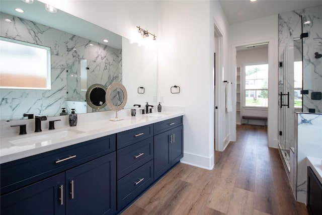 3314 Arbor St, Houston, TX 77004 - bathroom with a marble finish shower, double vanity, wood finished floors, and recessed lighting
