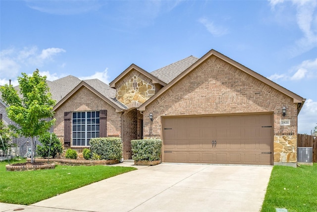 2821 Redbud Ln, Melissa, TX 75454 - view of front of house with an attached garage, driveway, and stone siding