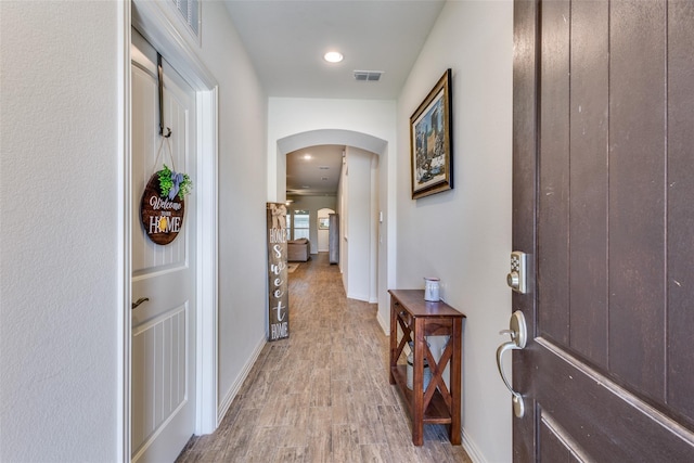 2821 Redbud Ln, Melissa, TX 75454 - corridor with arched walkways and light wood-style floors
