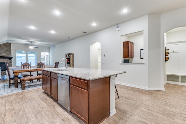 2821 Redbud Ln, Melissa, TX 75454 - kitchen featuring stainless steel dishwasher, ceiling fan, light wood-style flooring, a stone fireplace, and recessed lighting