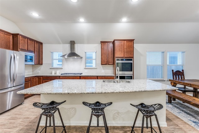 2821 Redbud Ln, Melissa, TX 75454 - kitchen with stainless steel appliances, wall chimney exhaust hood, a breakfast bar, recessed lighting, and light stone countertops