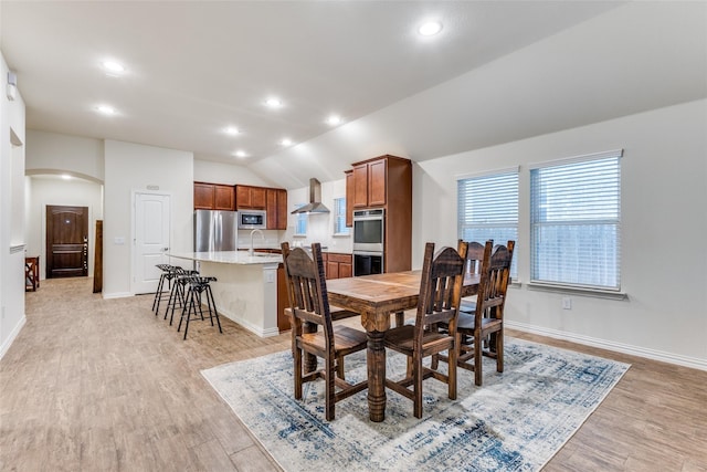 2821 Redbud Ln, Melissa, TX 75454 - dining area with arched walkways, vaulted ceiling, light wood-type flooring, and recessed lighting