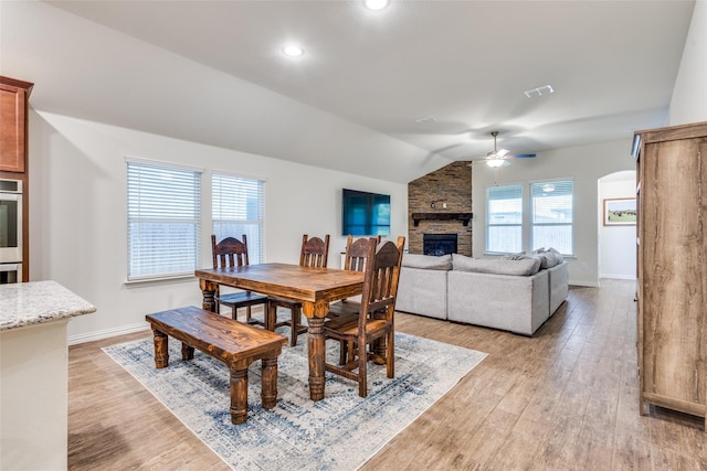 2821 Redbud Ln, Melissa, TX 75454 - dining room featuring a ceiling fan, a stone fireplace, light wood finished floors, lofted ceiling, and recessed lighting