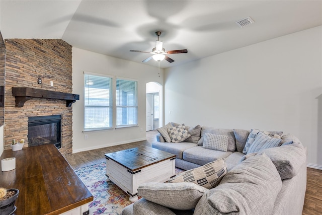 2821 Redbud Ln, Melissa, TX 75454 - living area with wood finished floors, a ceiling fan, arched walkways, a fireplace, and lofted ceiling