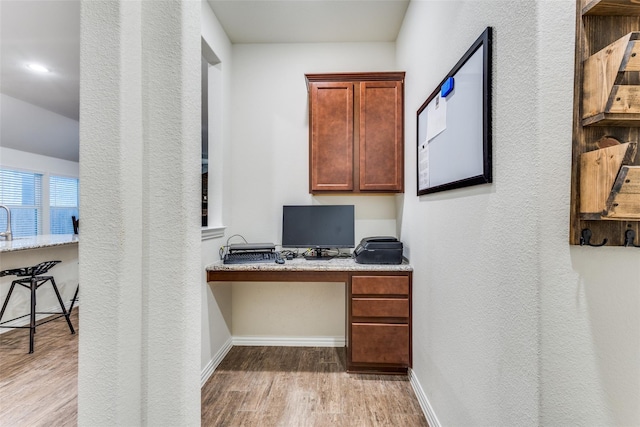 2821 Redbud Ln, Melissa, TX 75454 - office area with built in study area, wood finished floors, and a textured wall