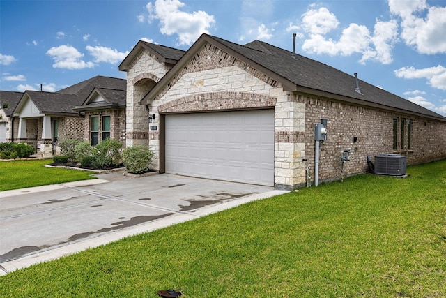 5311 Latigo Ct, Alvin, TX 77511 - view of front facade featuring driveway, a garage, stone siding, and a front yard