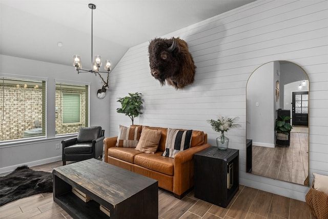 5311 Latigo Ct, Alvin, TX 77511 - living area featuring wood tiled floors, a chandelier, arched walkways, vaulted ceiling, and wood walls