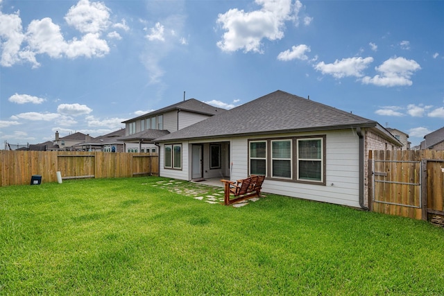 5311 Latigo Ct, Alvin, TX 77511 - rear view of property with a fenced backyard, a shingled roof, and a patio area