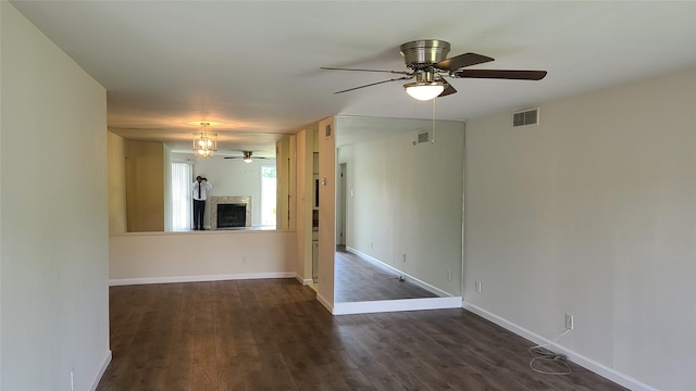 8787 Brae Acres Rd Unit 104, Houston, TX 77074 - spare room with a ceiling fan, a fireplace, and dark wood finished floors