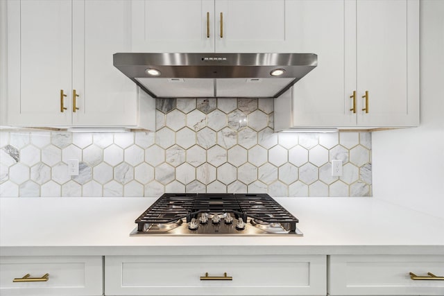 3312 Arbor St, Houston, TX 77004 - kitchen featuring ventilation hood, stainless steel gas stovetop, light countertops, white cabinets, and backsplash
