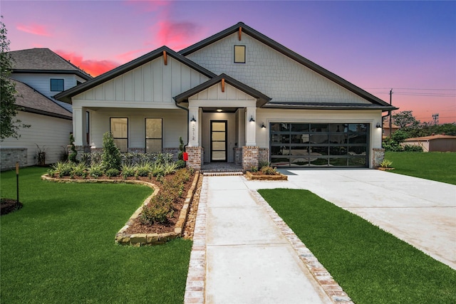 3312 Arbor St, Houston, TX 77004 - view of front of property featuring board and batten siding, driveway, a garage, and a front yard