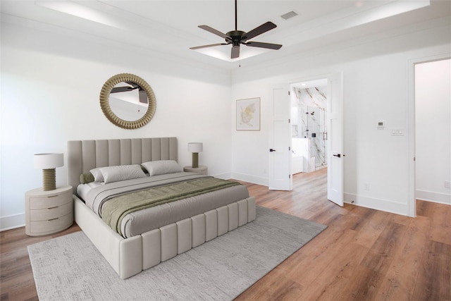 3312 Arbor St, Houston, TX 77004 - bedroom with wood finished floors, a raised ceiling, and a ceiling fan