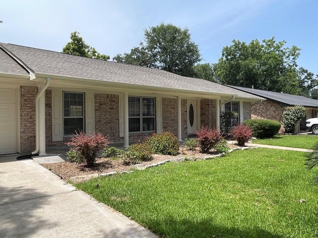 2202 Mockingbird Ln, Baytown, TX 77520 - ranch-style house featuring a front yard, brick siding, and a shingled roof