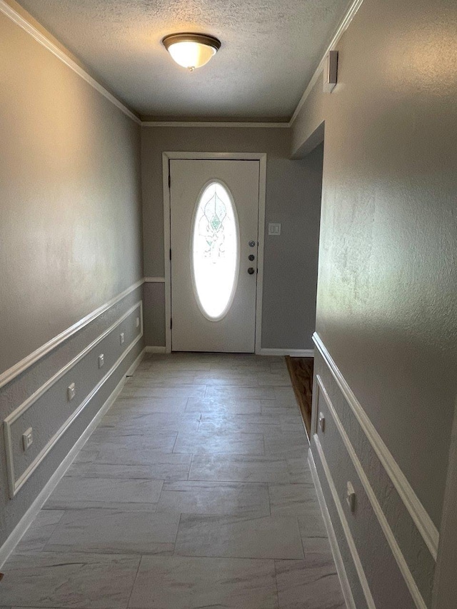 2202 Mockingbird Ln, Baytown, TX 77520 - foyer featuring crown molding and a textured ceiling