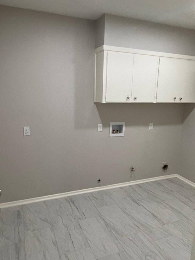 2202 Mockingbird Ln, Baytown, TX 77520 - laundry room featuring hookup for a gas dryer, cabinet space, light marble finish flooring, and washer hookup