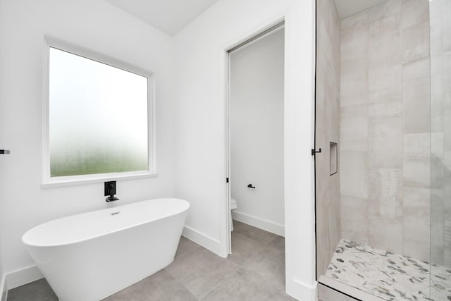 1913 W St, Houston, TX 77026 - bathroom with a freestanding tub, a stall shower, and tile patterned flooring