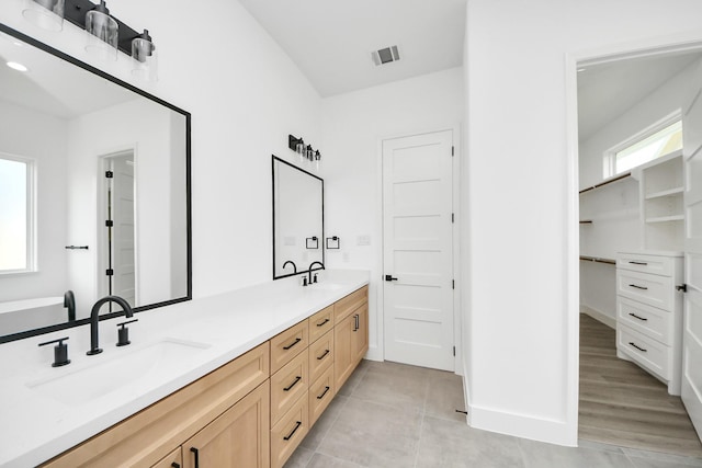 1913 W St, Houston, TX 77026 - full bathroom with double vanity, a spacious closet, and tile patterned floors