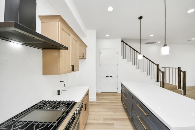 1913 W St, Houston, TX 77026 - kitchen featuring wall chimney range hood, stainless steel gas range, light brown cabinetry, light wood finished floors, and recessed lighting