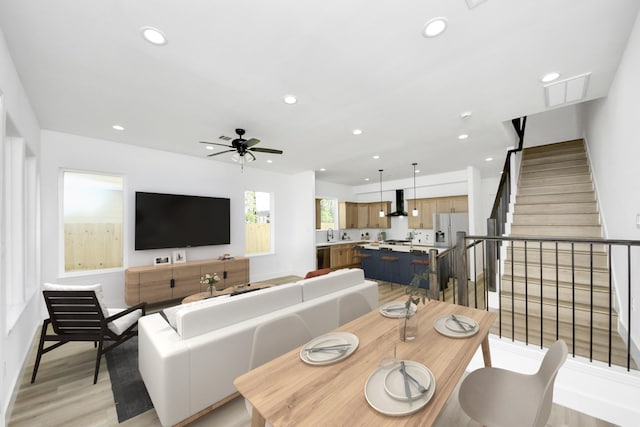 1913 W St, Houston, TX 77026 - living area featuring recessed lighting, light wood-style flooring, a ceiling fan, and stairway