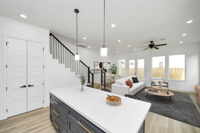 1913 W St, Houston, TX 77026 - kitchen featuring light wood-style floors, light countertops, recessed lighting, a kitchen island, and a ceiling fan