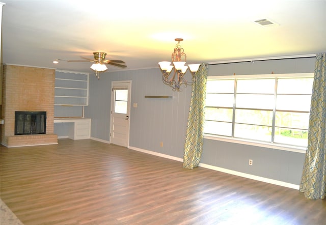 101 Summit Dr, Conroe, TX 77303 - unfurnished living room featuring wood finished floors, a chandelier, a ceiling fan, and a brick fireplace